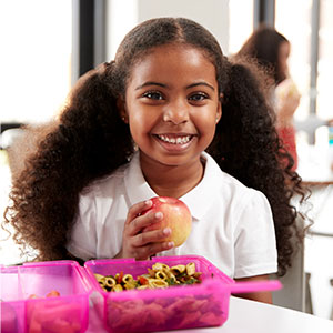 girl eating a healthy school lunch