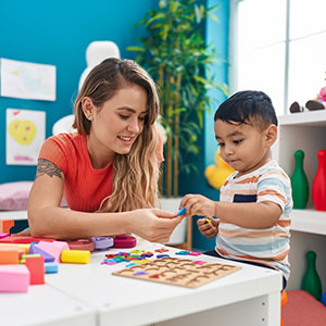 A teacher with a little boy at Smart Kids Day Nursery