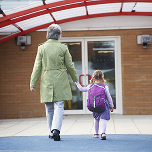 A woman walking her granddaughter to Smart Kids Day Nursery