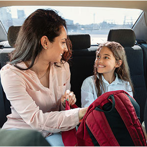 A mother and her daughter in the car on the way to Smart Kids Day Nursery