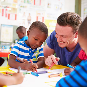 Male teacher and little boy at Smart Kids Day Nursery
