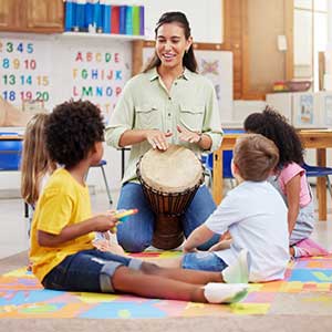 Children in a music lesson with teacher at Smart Kids Day Nursery